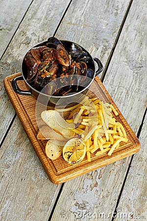 Top view saucepan with mussels and side dish. Stock Photo