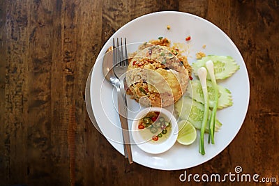 Top View Seafood Tom Yum Fried Rice Served in a white round dish With fish sauce, peppers Stock Photo