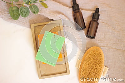 Top view of a selection of body care items including a soap bar, a massage brush, and spray bottles Stock Photo