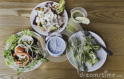 Selective focus of blue clock which the healthy Concept of intermittent fasting, breakfast time, diet food and weight Stock Photo