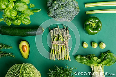 Top view set of healthy raw vegetables on the green background with. Vegetarian and vegan diet diet eating and cooking. Veganism Stock Photo