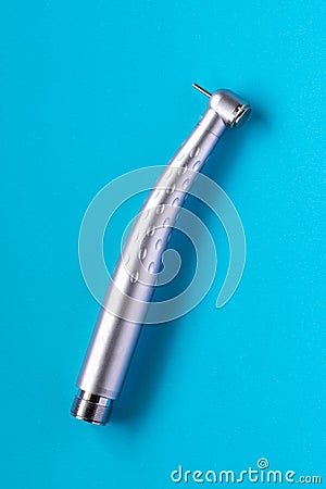 Top view shot of a dental high-speed handpiece on the blue background Stock Photo