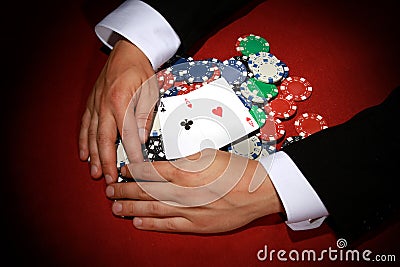 Top view shot of a poker player taking a big pile of poker chips and playing cards Stock Photo