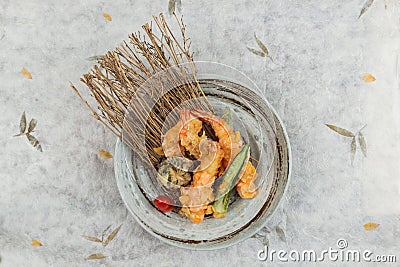 Top view of Shrimp and shiitake tempura with chilli served in ink painted round stone plate on washi Japanese paper Stock Photo