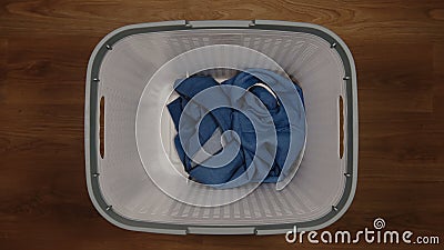 TOP VIEW: Single cloth in a laundry basket on a floor Stock Photo