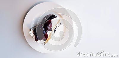 Top view of slice of blueberry cheesecake on white dish or plate with copy space on right. Stock Photo