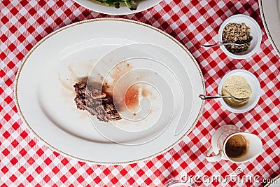 Top view of Sliced medium rare charcoal grilled wagyu Ribeye steak in white plate on red and white pattern tablecloth. Stock Photo