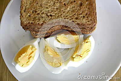 Top view of slices of toasted whole wheat bread with boiled eggs on a plate for breakfast Stock Photo