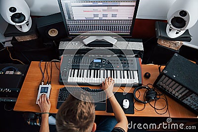 Top view. Sound engineer working and mixing music indoors in the studio Stock Photo