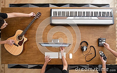 Top view of sound engineers at wooden table working in studio Stock Photo