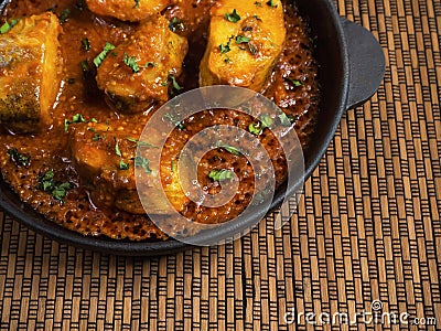 Top view of spicy and hot Bengali fish curry. Indian food. Fish curry with red chili, curry leaf, coconut milk. Asian cuisine. Stock Photo