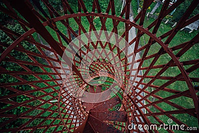 Top view of spiral staircase of rusty abandoned water tower. First hyperboloid of engineer Shukhovl Stock Photo