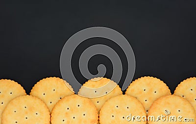 Top view stack of round cheese cracker cookies with sugar on black color background, copy space Stock Photo
