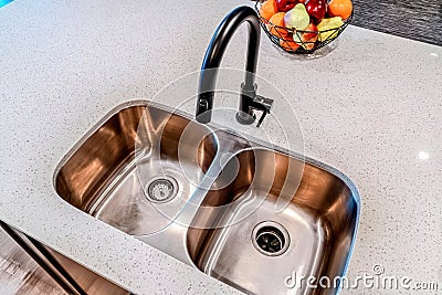 Top view of stainless steel double basin undermount sink and black curved faucet Stock Photo