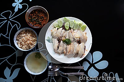 Top view Steamed chicken rice with chili sauce and soup on black table background. Asia foods concept Stock Photo