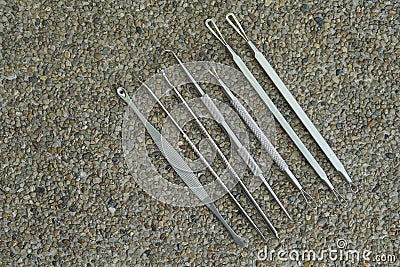 Top view steel ear pick kit on stone background, object, copy space Stock Photo