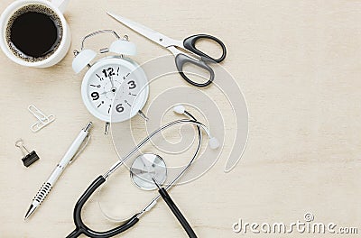 Top view stethoscope with clock coffee scissors. Stock Photo