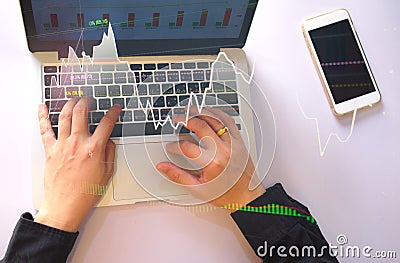 top view stock trader using laptop with stock market graph Stock Photo