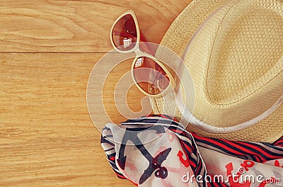 Top view of stylish hat woman sunglasses and tablet fashion nautical scarf over wooden table. vacation and travel concept Stock Photo