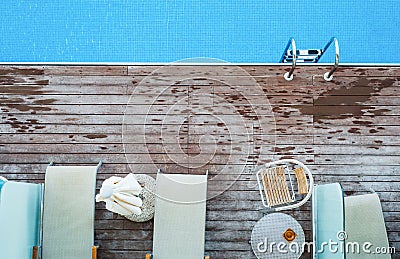 A top view of sunbathing deck and private swimming pool near beach, summer holiday concept. Stock Photo