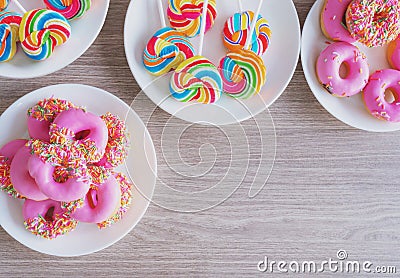 Top view, sweet food on wooden table. Glazed mini donuts and candy sugar Stock Photo