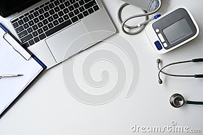 Top view table doctor work desk with laptop, Blood pressure, Stethoscope with clip board and pen Stock Photo