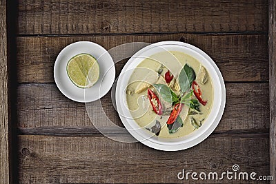 Top view Thai food chicken green curry on rustic wooden table Stock Photo