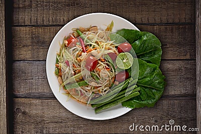 Top view Thai food rice noodle papaya salad on wooden table Stock Photo