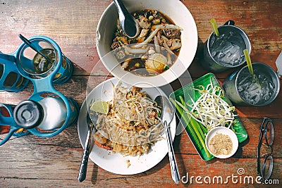 Top view thai street food on old wooden table padthai and guay jub noodle, popular traditional thai dish Stock Photo