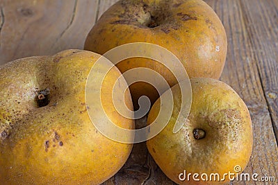Top view of three apple orchard reinetas on weathered wooden background Stock Photo
