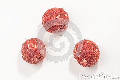 Top view on three raw meatballs on white background Stock Photo