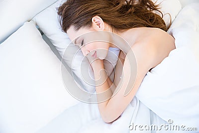 Top view of tired beautiful young woman sleeping on bed Stock Photo