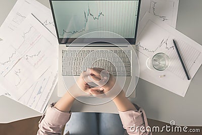 Top view. Tired business woman with headache at office with glass of water and pill on the background of graphics and charts print Stock Photo