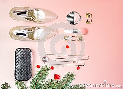 Flat lay to Christmas Valentines day party outfit shoes accessories jewelry makeup clutch cosmetic brushes fir tree background in Stock Photo