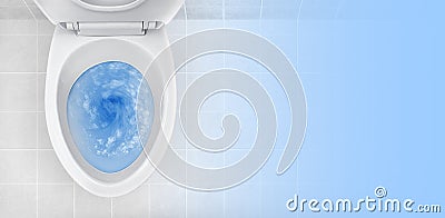 Top view of toilet bowl, blue detergent flushing in it Stock Photo