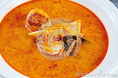 Top view on tom yum soup served in white plate with rice. soup with shrimp, seafood, coconut milk and chili pepper in bowl copy Stock Photo
