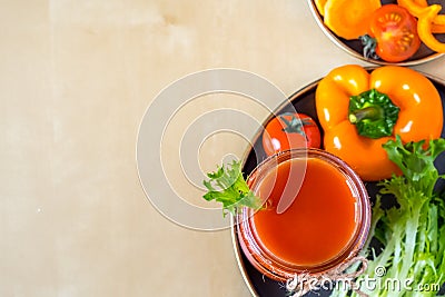 Top view tomato smoothie in a glass jar with the ingredients for its preparation. Fresh tomatoes, carrots, bell peppers and Stock Photo