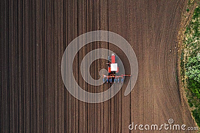 Top view of tractor planting corn seed in field Stock Photo