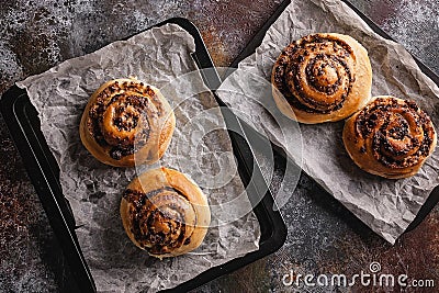 Top view traditional fresh sweet homemade cinnamon rolls with chocolate cream on a baking sheet. Scandinavian cuisine. Hyugge Stock Photo