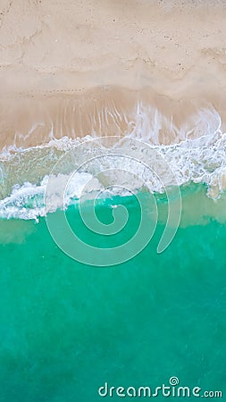 Top view at a tropical beach with waves and blue ocean Drone aerial view at Freedom beach in Phuket Stock Photo