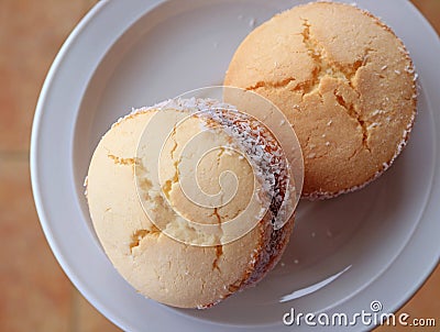 Top view of two Alfajores, traditional Latin American sweets served on a white plate Stock Photo