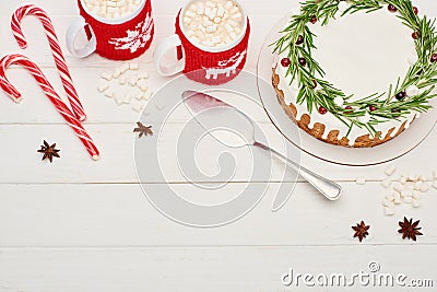 Top view of two cups of cocoa with marshmallows and christmas pie with icing on white wooden table. Stock Photo