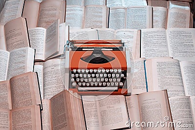 Top view typewriter is on many open books Stock Photo