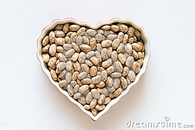 Uncooked Pinto Beans in a Heart Shaped Bowl Stock Photo