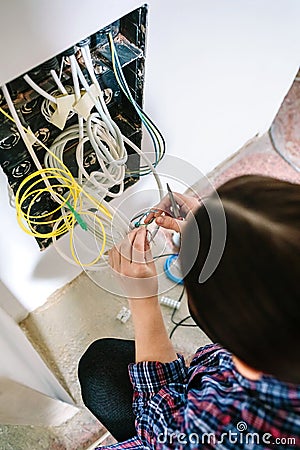Unrecognizable female technician installing lan network Stock Photo