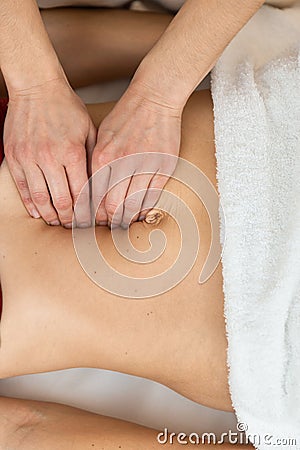 Hands of physiotherapist checking diastasis recti on belly of postpartum woman Stock Photo