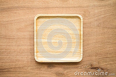 Top view of unused brand new brown handmade wooden dish plate on wooden table background Stock Photo