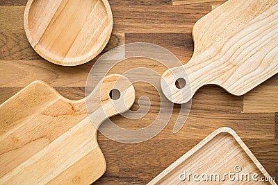 Top view of unused brand new brown handmade wooden kitchen utensil, dish plate and cutting board on wooden table background Stock Photo