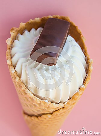 Top view vanilla ice cream cone scoop with chocolate chip cookies on pink background, vertical shot Stock Photo