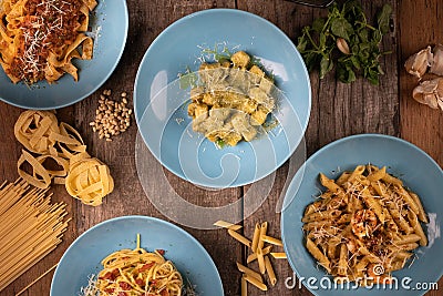 Top view variety of homemade prepared pasta isolated on wooden table Stock Photo